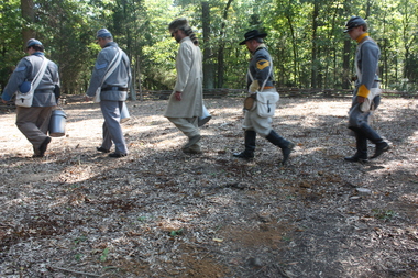 Members of the Sons of Confederate Veterans spread red Alabama dirt across the new cemetery at Bristoe Station Battlefield Heritage Park in Bristow, Va. (Mary Orndorff Toryan | Birmingham News)